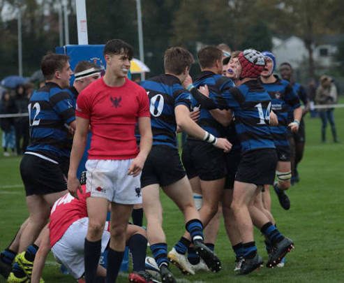 Rugby players celebrating together after a match