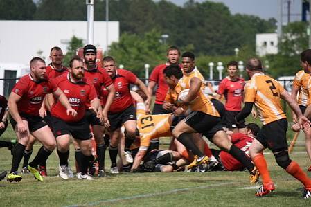 Professional rugby players competing for the ball during a club match