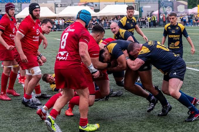 Rugby forwards locked in a scrum, showing the physical power scouts assess